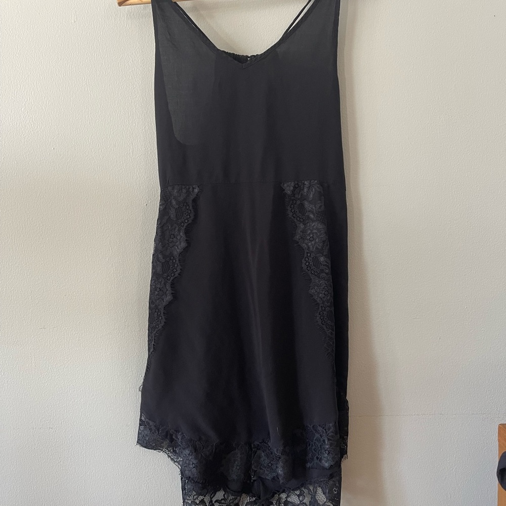 Free People slip dress. Tie back. Lace and asymmetrical handkerchief hem. Black